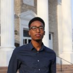 Malcolm stands outside the chapel at Lawrence University 